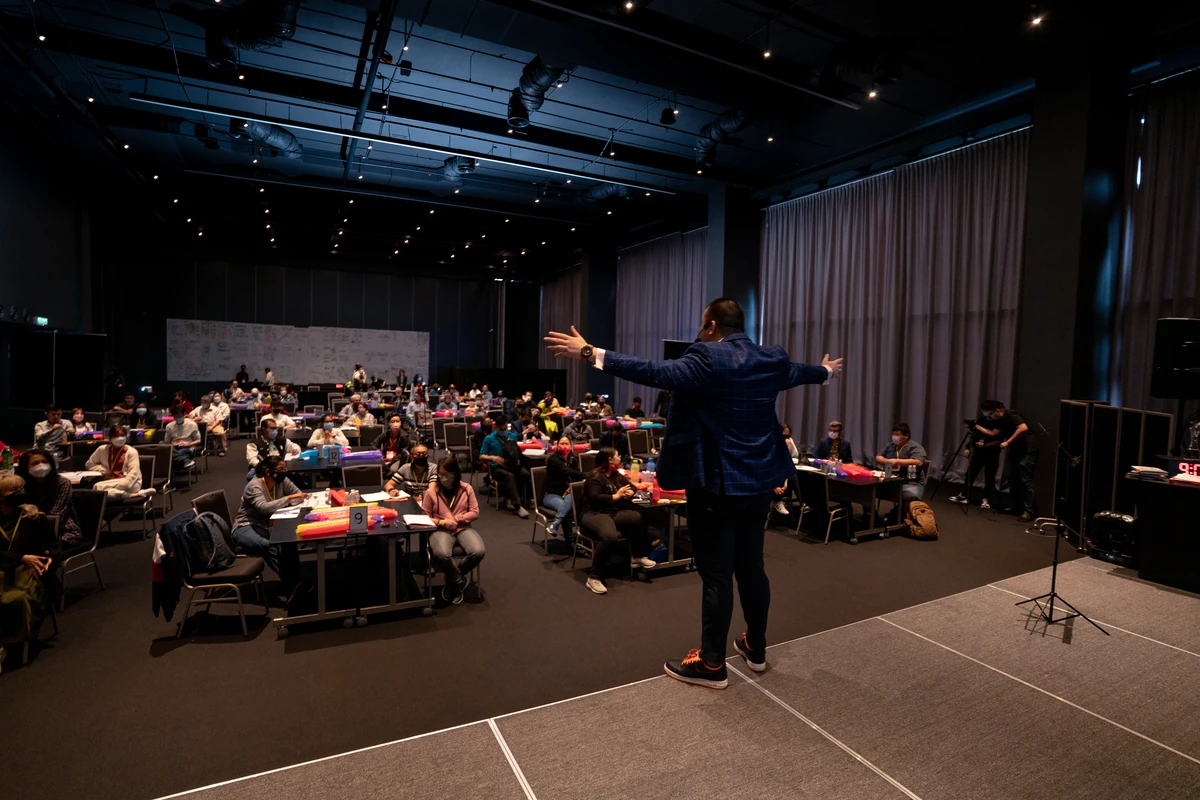 A speaker presenting to a live audience